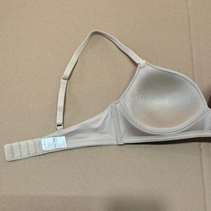 Detail view of the soft inner cup and care label of a seamless wireless nude bra