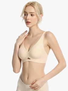 Detail view of seamless beige wireless bra featuring a deep V-neck and cut-out front design