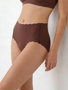 Detailed side view of seamless high-waist panties with scalloped wavy edges in brown