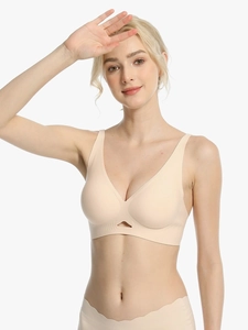 Detailed view of the deep V-neck and triangle hollow-out design on a seamless beige bra
