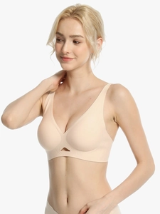 Close-up of seamless beige deep V-neck bra featuring cut-out detail and crossover back