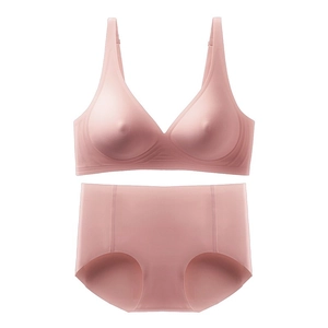 Detailed view of seamless pink wireless bra and high-waist brief set on white background