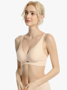 Detail of nude seamless bra featuring deep V-neck and triangular cutout for comfort