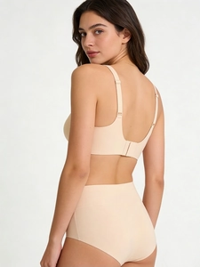 U-shaped back design of seamless nude bra set with adjustable straps on female model