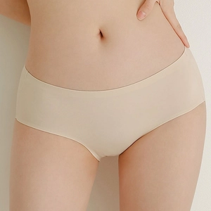 Detailed close-up of seamless beige underwear showing smooth elastic fabric and folded edges