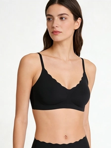 Detailed view of seamless black V-neck bra set with scalloped wavy edges for women
