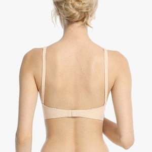 Back view of skin-toned seamless bra with thin adjustable straps and microfiber texture