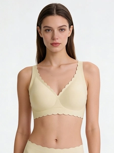 Detail of light yellow seamless bra set featuring scalloped wave edges and soft fabric