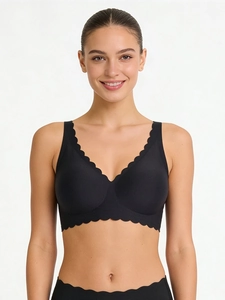 Close-up of black seamless deep V bra featuring scalloped edges and soft support fabric