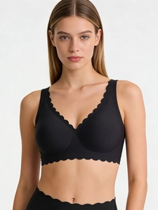 Close-up of black seamless bra featuring scalloped edges and deep V-neck design