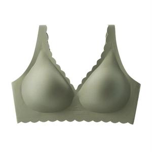 Close-up detail of seamless olive green bra featuring scalloped wavy edges and soft support
