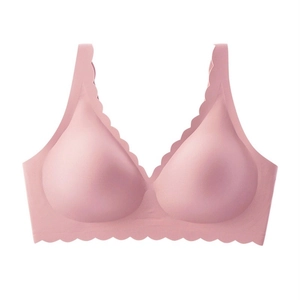 Close-up of pink seamless deep V bra with elegant scalloped edges and wide straps