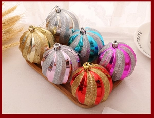 Detailed view of colorful pumpkin striped Christmas baubles in a festive home setting