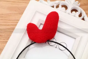 Detail of red plush antler headpiece decoration on a vintage frame for party celebration