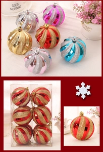 Close-up of spiral glitter Christmas ornaments in red and gold with hanging loops