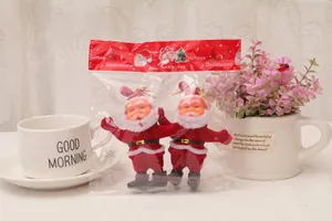 Two miniature Santa Claus hanging ornaments packaged in a transparent bag with gold cords