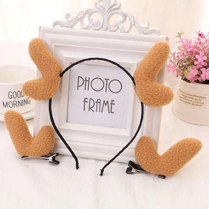 Detail view of plush reindeer antler headband and clips set in warm white aesthetic