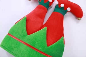 Detail of red and green plush elf leg ornaments with white pom poms and golden bells