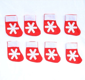 Set of 8 mini Christmas stocking cutlery holders with white snowflakes on red felt