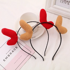 Handmade plush reindeer antler headbands in red and brown for Christmas parties