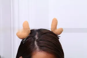 Detail of plush brown reindeer antler hair clips featuring sturdy black metal duckbill base