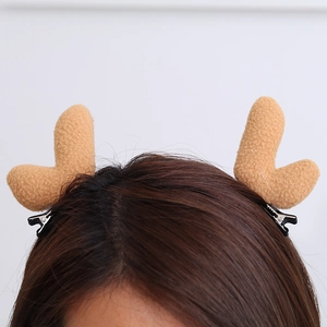 Detail of plush camel reindeer antler hair clips with metal duckbill clips on a model