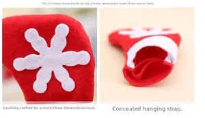 Detail of Christmas stocking cutlery holder made of red non-woven fabric with snowflake pattern