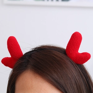 Close-up of a model wearing the soft red plush reindeer antler headband for Christmas party