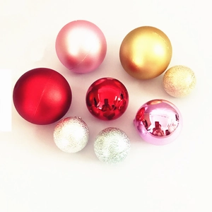 Assorted Christmas cake topper spheres in red, gold, and silver with matte and glitter finishes