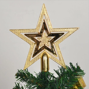 Detailed macro view of triple-layered golden Christmas tree star topper on green pine branch