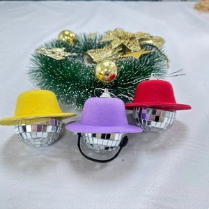 Close-up of mini mirror disco balls with colorful party hats and hanging silver cords
