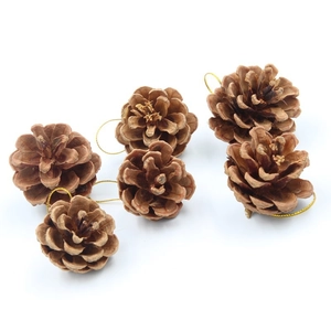 Detail of natural brown pine cones with gold hanging loops for Christmas tree decoration