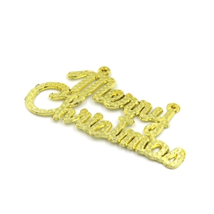 Close-up of golden Merry Christmas sign hanging ornament for holiday decoration