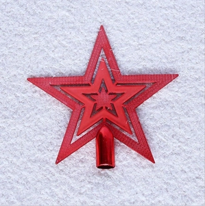 Detail of red glittered Christmas tree topper star with layered five-point design