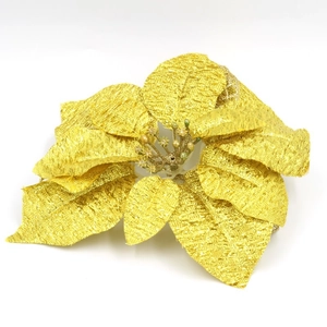 Detailed macro view of a golden Christmas poinsettia flower with intricate woven textures