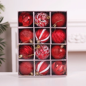 Detailed close-up of 12 red Christmas ornaments with diverse textures in a display box