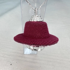 Close-up of a mini red felt top hat with a faceted crystal disco ball ornament