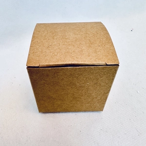 Macro detail of natural kraft paper gift box texture and eco-friendly cube structure