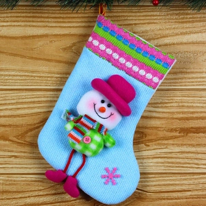 Close-up of a blue knitted Christmas stocking with a 3D snowman and colorful stripes