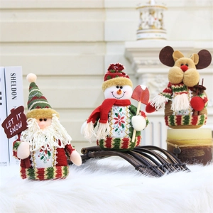 Three 18cm Christmas plush dolls including Santa and Snowman with festive shovel decoration