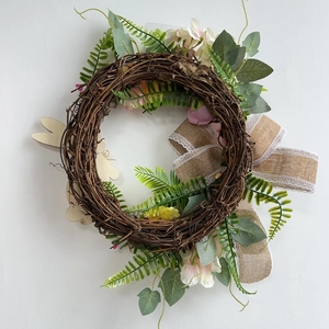 Easter bunny wreath with faux greenery, flowers and linen bow for home wall decor