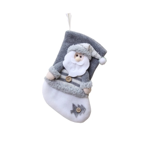 Gray and white Christmas stocking with a 3D Santa Claus figure and knitted details