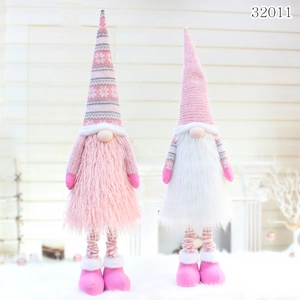 Close-up of pink knitted Christmas gnomes with snowflake patterns and soft faux fur beards