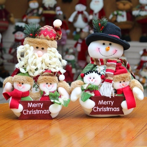 Plush Christmas Santa and Snowman figures with Merry Christmas sign on wood base