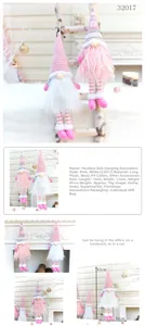 Close-up of pink and white plush gnome ornaments with knitted hats in holiday scene