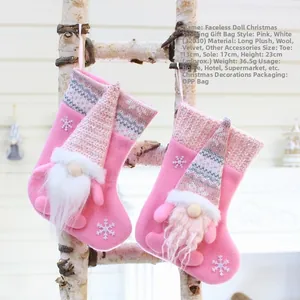 Detailed view of pink knitted gnome Christmas stocking with sequins and plush white beard