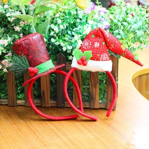 Christmas headbands with red glitter top hat and classic snowflake patterns on wooden desk