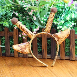 Detailed view of a giraffe print headband with soft plush ears and pom-pom horns