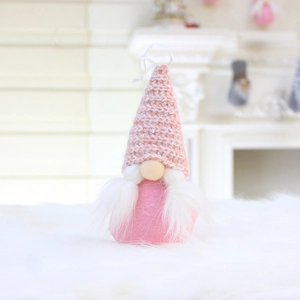 Close-up of pink knit gnome plush with silver sequins and soft white faux fur beard