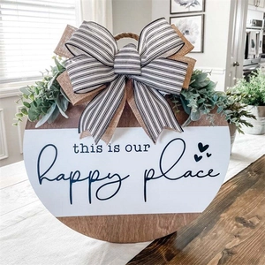 Round wooden welcome sign with bow and greenery decor this is our Happy place